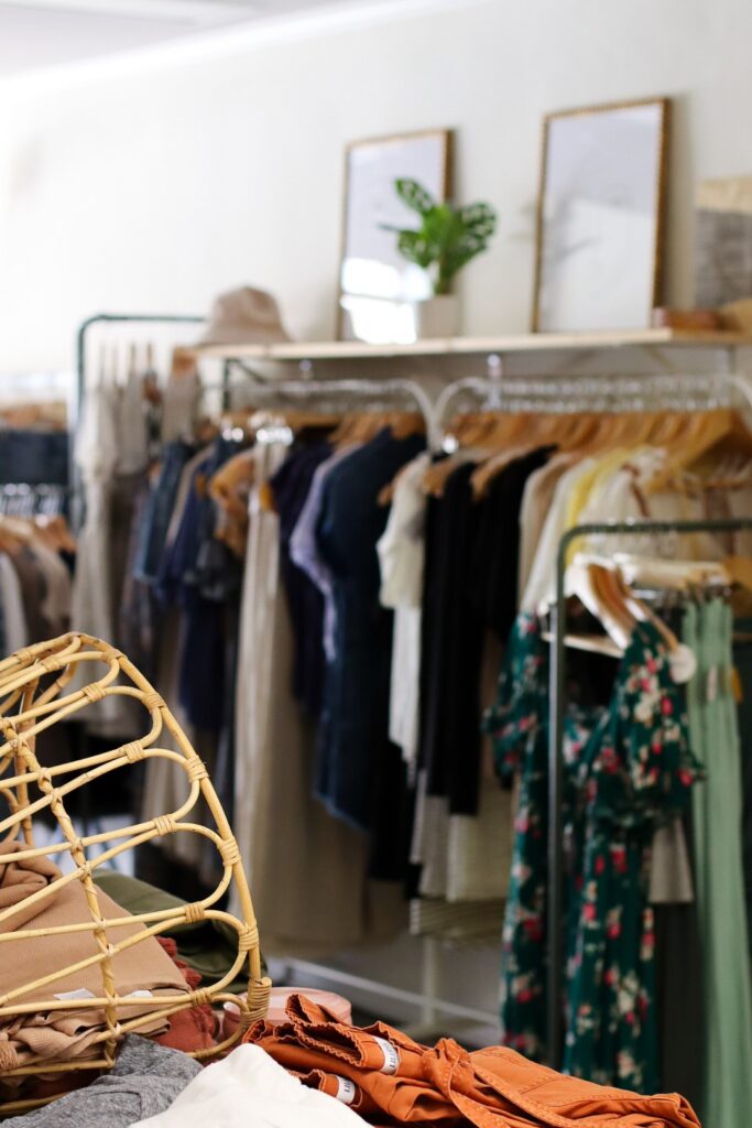 The bright and inviting ground-floor storefront of Lemon at 126 East Main Street in historic downtown McMinnville, featuring large glass windows displaying stylish women's apparel.