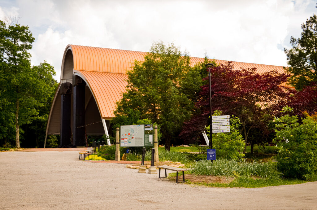The sprawling, 39,000-square-foot Mahima meditation hall with its distinct copper-colored dome, nestled among the lush forests and rolling hills of the Cumberland Plateau.