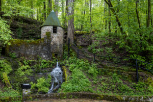 Historic stone Spring Castle at Rock Island State Park, Tennessee, surrounded by lush spring greenery and moss-covered rocks