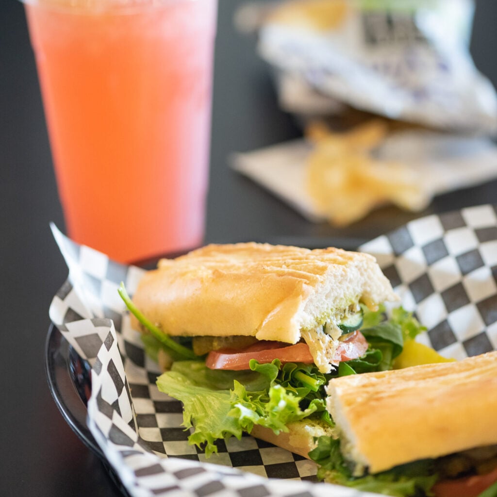 A custom-made deli sandwich wrapped and ready for a picnic from Topz Metro Deli.
