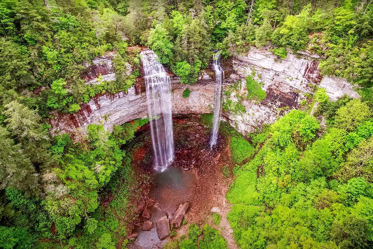 The towering 256-foot drop of Fall Creek Falls plunging into a deep, forested gorge.